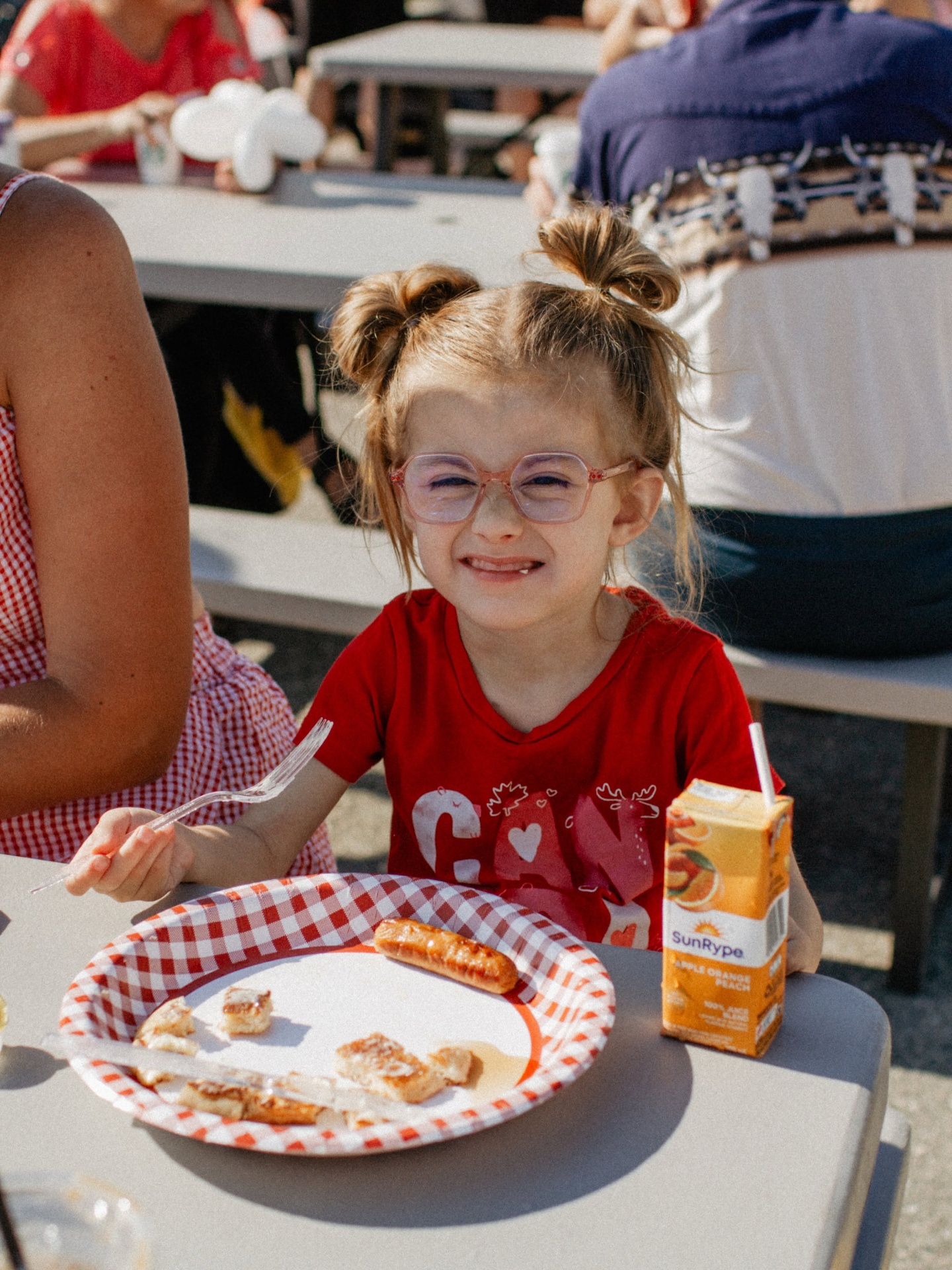 Child enjoying a Canada Day pancake breakfast